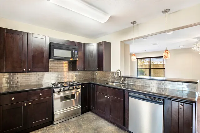 a view of kitchen with microwave and stove