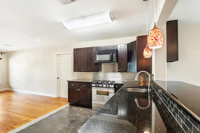 a kitchen with a sink and cabinets