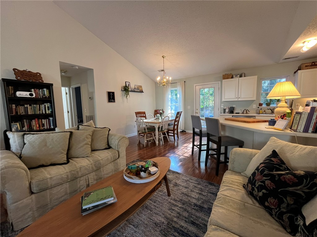 116 Arbors Court Central, SC 29630 - Photo 3 of 27 An open concept living area boasts rich hardwood flooring and a vaulted ceiling.