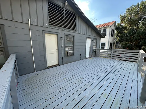 a view of a house with wooden deck