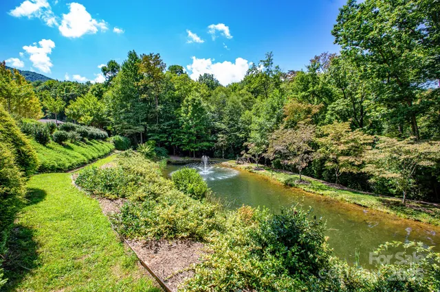 a view of a backyard with wooden fence