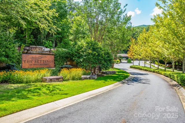 a sign that is sitting in front of flowers