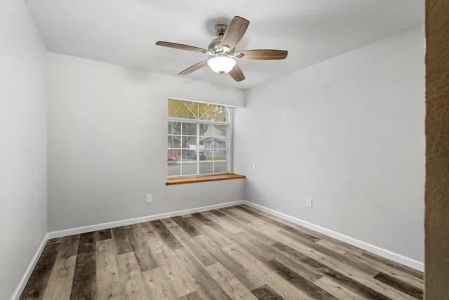 wooden floor in an empty room with a window