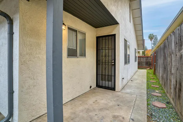 a view of a house with backyard and wooden door