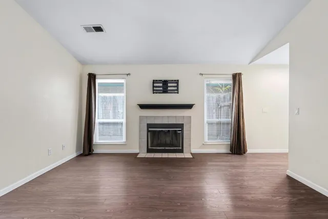 a view of a livingroom with a fireplace and a window
