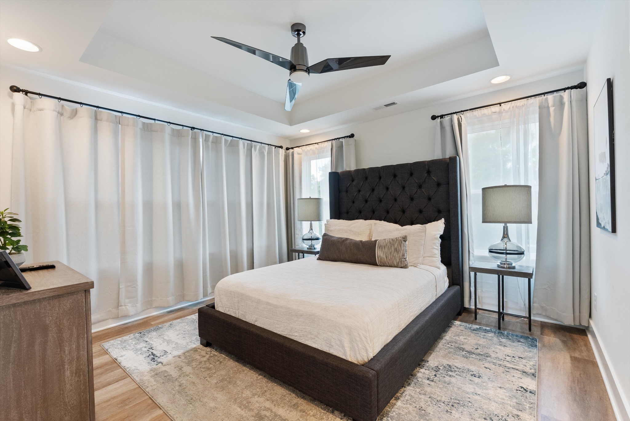 906 North Maple Street Murfreesboro, TN 37130 - Photo 14 of 39 a bedroom with a large bed and a chandelier