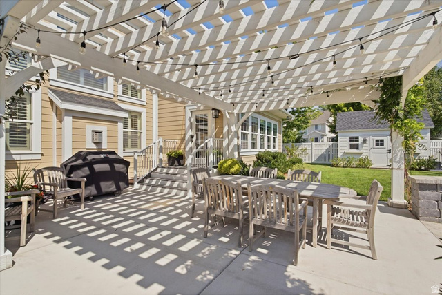 1257 Rigby Road Kaysville, UT 84037 - Photo 43 of 55 Spacious concrete patio featuring a white pergola with string lighting