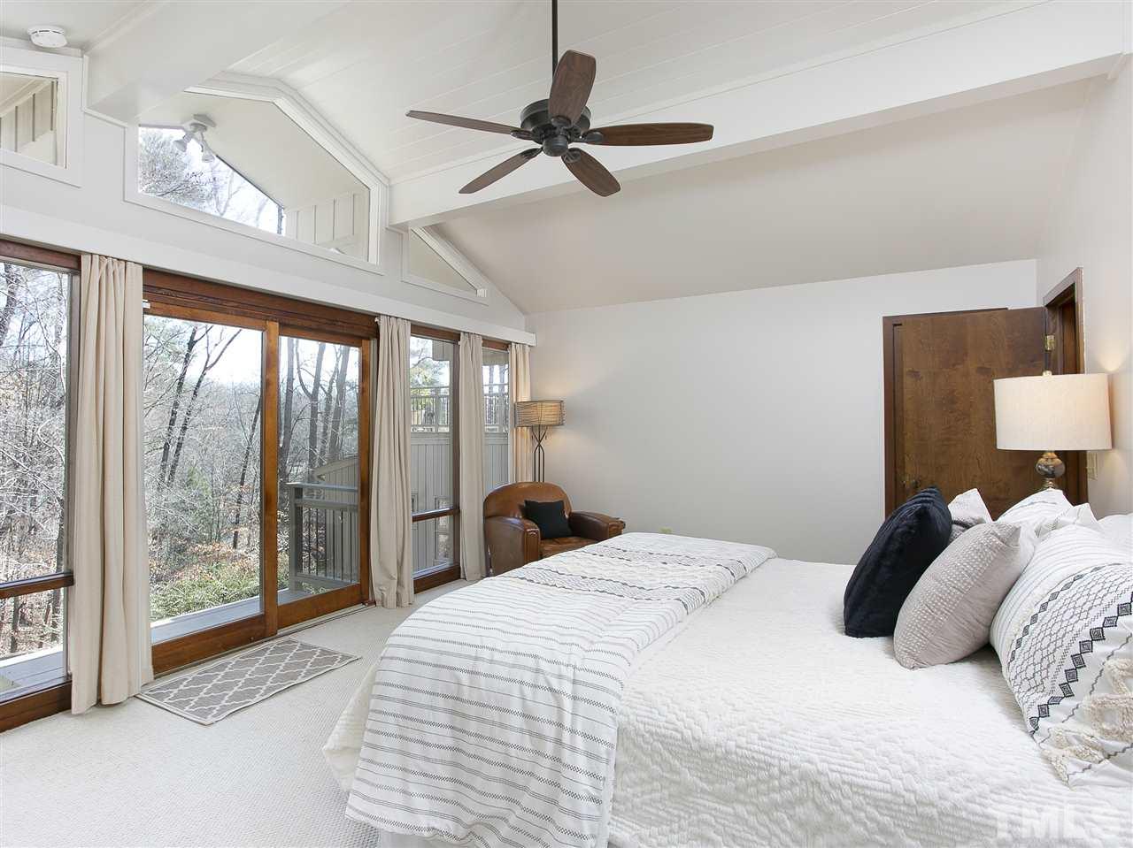 806 Kenmore Road Chapel Hill, NC 27514 - Photo 15 of 30 a bedroom with a large bed and a large window