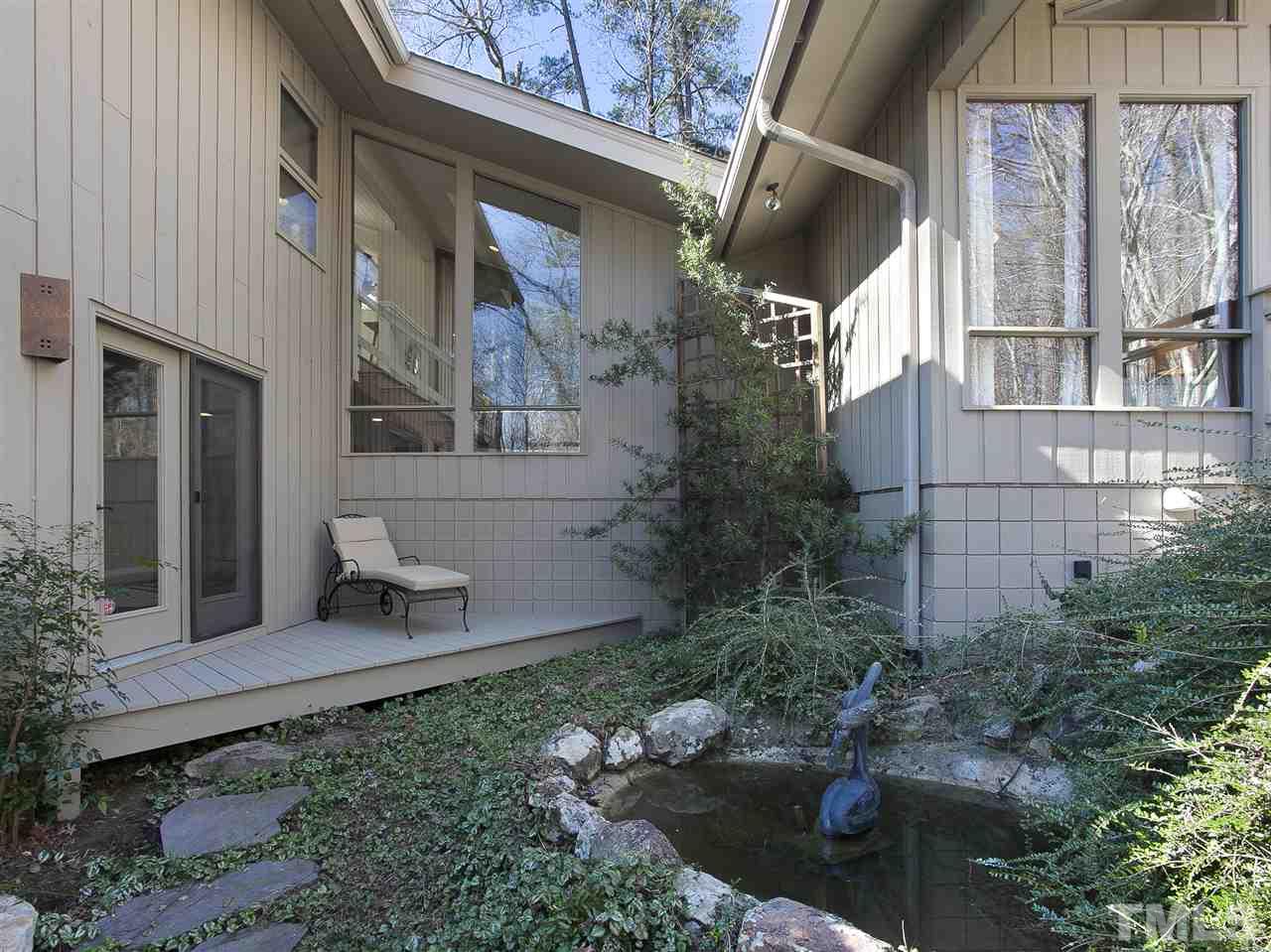 806 Kenmore Road Chapel Hill, NC 27514 - Photo 16 of 30 a view of a building with a backyard and garden