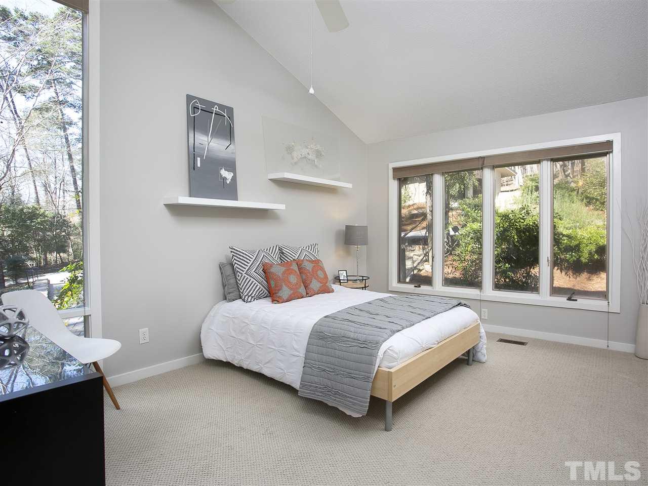 806 Kenmore Road Chapel Hill, NC 27514 - Photo 20 of 30 a bed sitting in a bedroom next to a window