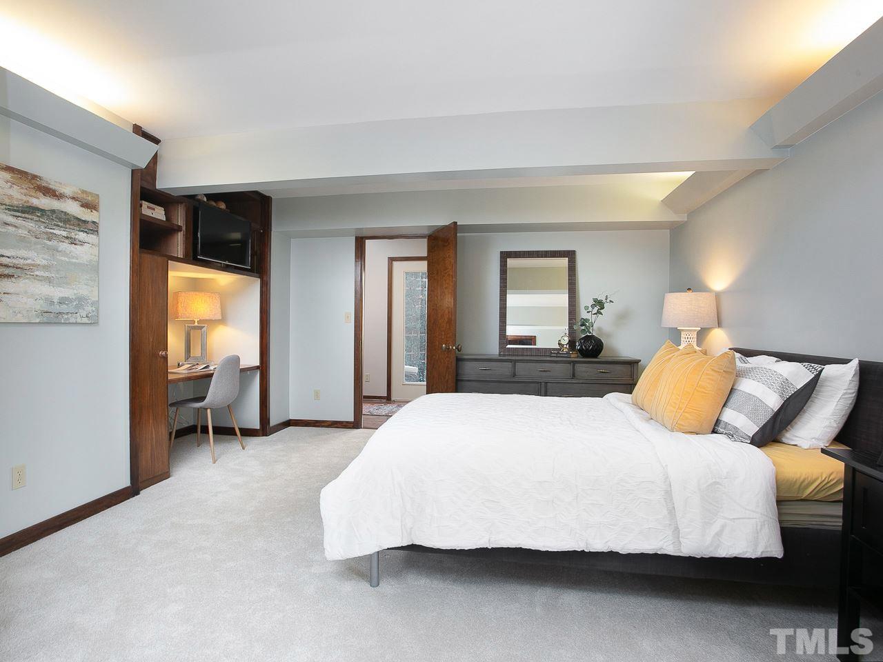 806 Kenmore Road Chapel Hill, NC 27514 - Photo 21 of 30 a bedroom with a bed and a large mirror