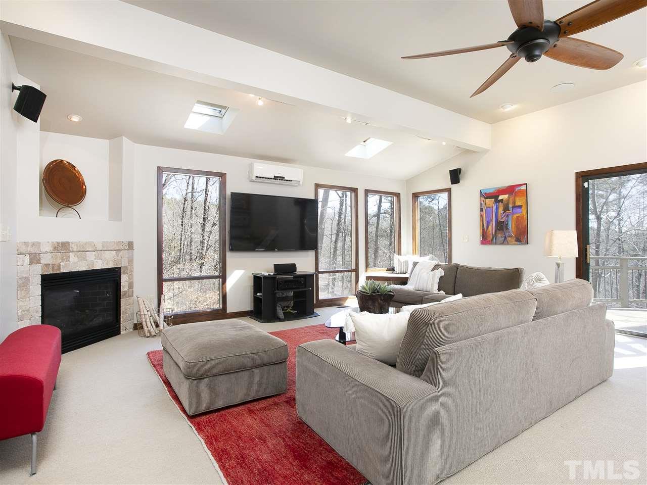 806 Kenmore Road Chapel Hill, NC 27514 - Photo 22 of 30 a living room with furniture a fireplace and a flat screen tv