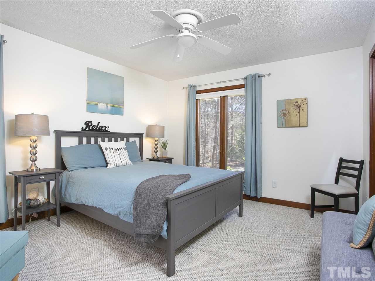 806 Kenmore Road Chapel Hill, NC 27514 - Photo 27 of 30 a bed room with a bed and a chandelier