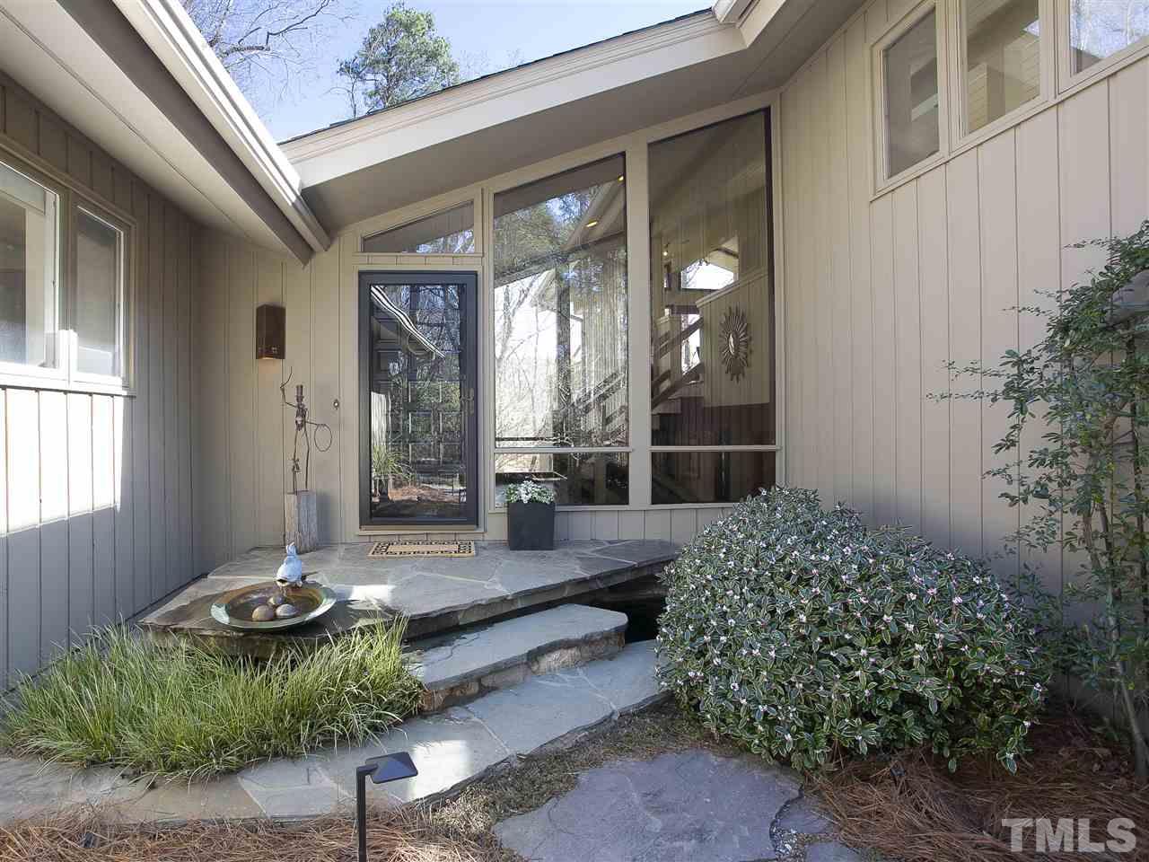 806 Kenmore Road Chapel Hill, NC 27514 - Photo 4 of 30 a backyard of a house with table and chairs