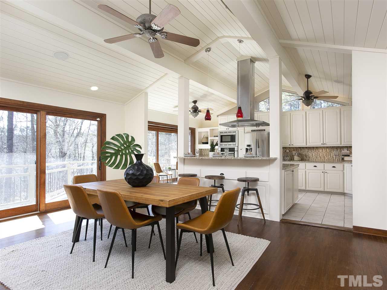 806 Kenmore Road Chapel Hill, NC 27514 - Photo 10 of 30 a view of a dining room with furniture and a floor to ceiling window