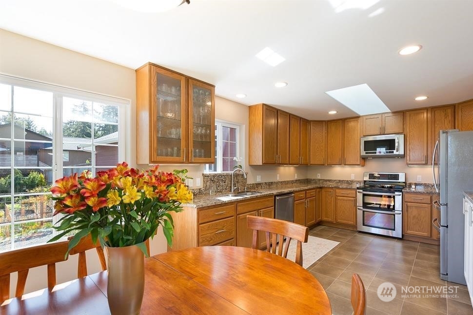 50 Henkes Road Sequim, WA 98382 - Photo 15 of 40 a kitchen with stainless steel appliances kitchen island granite countertop a stove a sink and a refrigerator