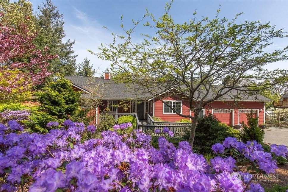 50 Henkes Road Sequim, WA 98382 - Photo 2 of 40 a front view of a house with a yard and fountain in middle of the house