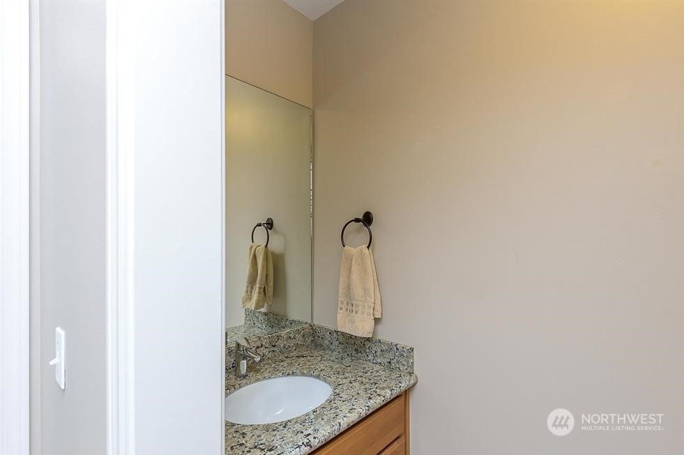 50 Henkes Road Sequim, WA 98382 - Photo 24 of 40 a bathroom with a granite countertop sink and a mirror