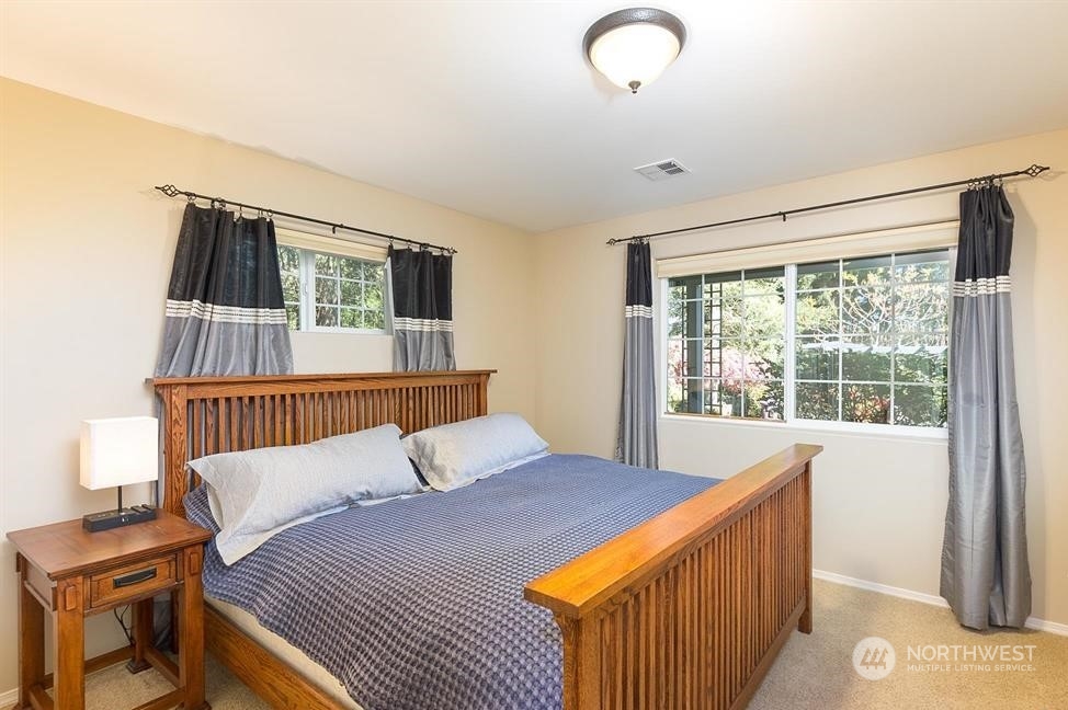 50 Henkes Road Sequim, WA 98382 - Photo 27 of 40 a bedroom with a bed and a window