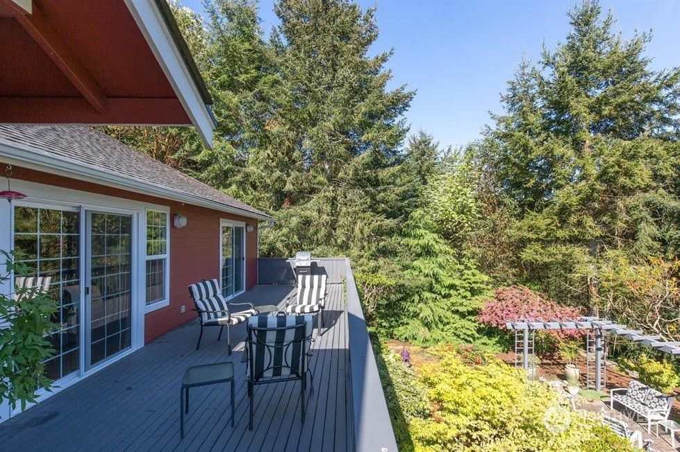 50 Henkes Road Sequim, WA 98382 - Photo 8 of 40 a view of a patio with table and chairs and potted plants