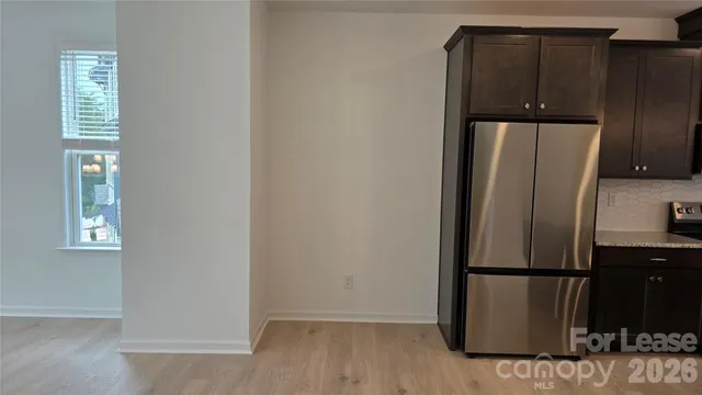 a view of a kitchen with refrigerator and cabinet