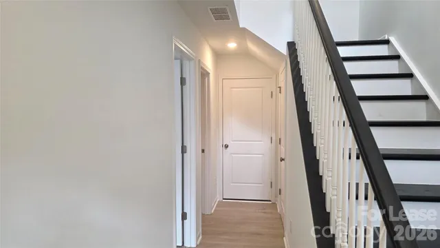 a view of staircase with white walls and a window