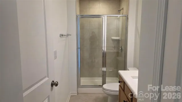 a bathroom with a shower and a toilet