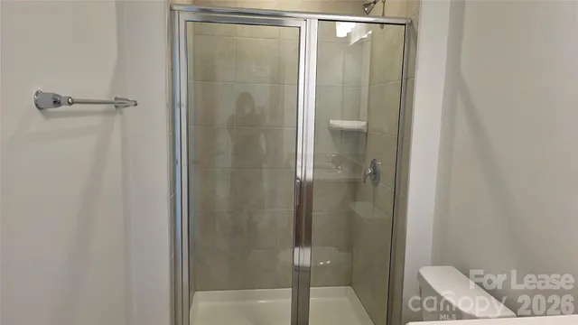 a bathroom with a glass shower door