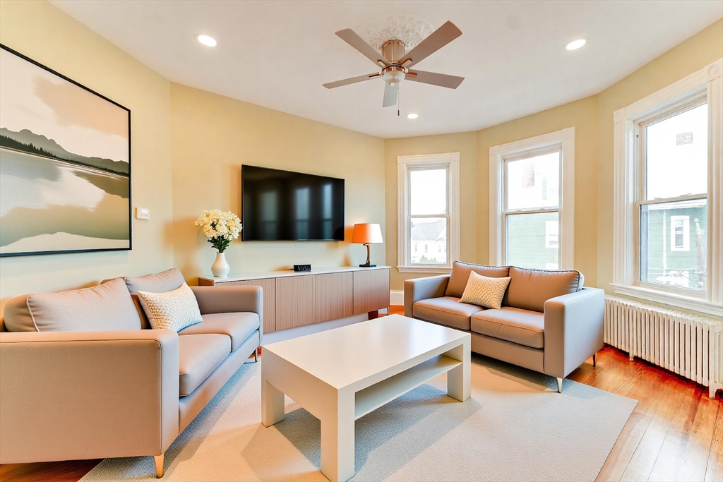 a living room with furniture and a flat screen tv