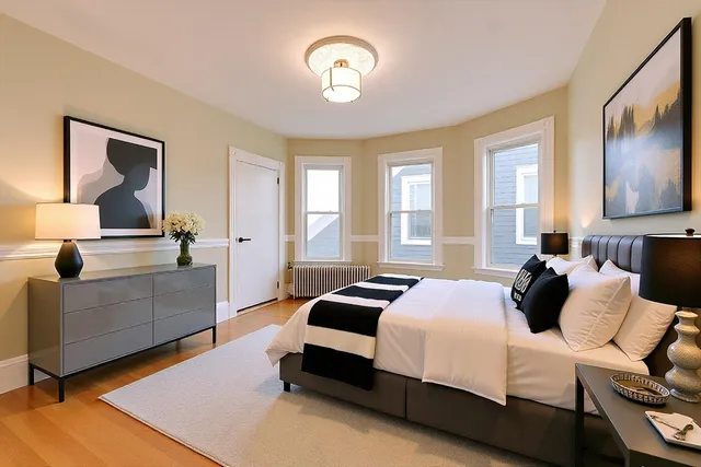 a bedroom with a bed and window