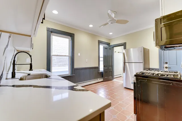 a kitchen with a sink appliances and cabinets