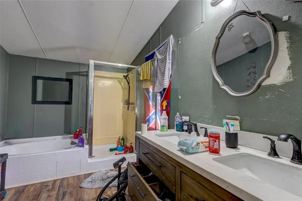 a bathroom with a tub sink and mirror