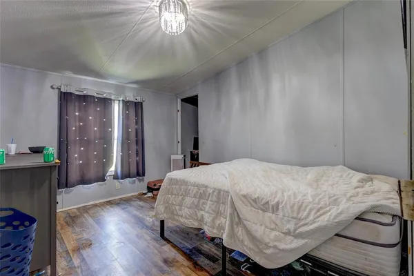 a bedroom with a bed and a chandelier