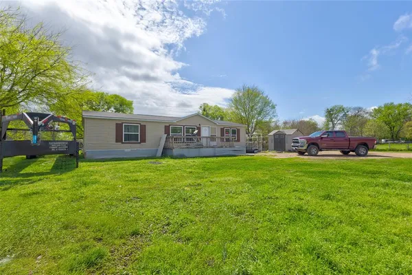 a view of house with backyard space and garden