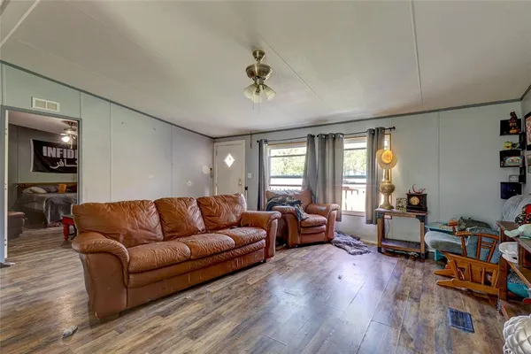 a living room with furniture or couch and a wooden floor