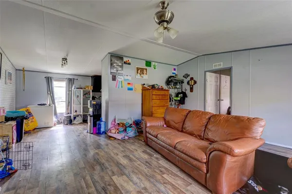 a living room with furniture and kitchen view