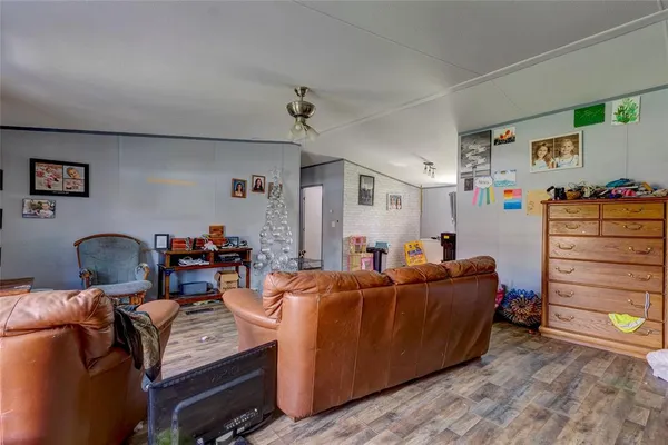 a living room with furniture a ceiling fan and a window
