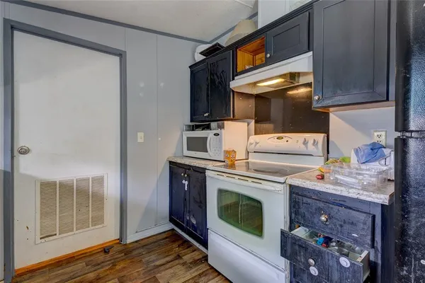 a kitchen with a stove and a microwave