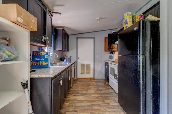 a kitchen with refrigerator and cabinets