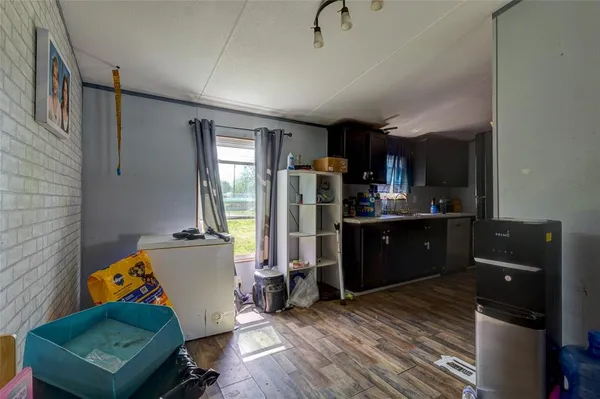 a kitchen view of a refrigerator a stove a sink and dishwasher with wooden floor