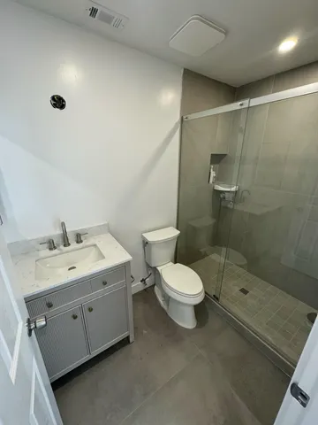 a bathroom with a toilet sink and shower