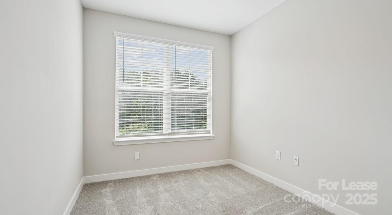 4010 Waiting Street, Unit C3 Matthews, NC 28105 - Photo 11 of 36 a view of an empty room with a window