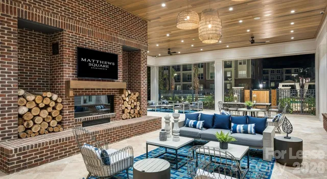 a living room with furniture a fireplace and a table