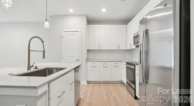 a kitchen with a sink cabinets and stainless steel appliances
