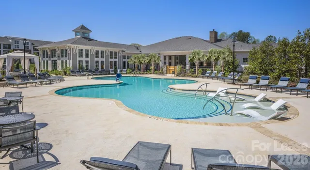 a view of a house with swimming pool and porch