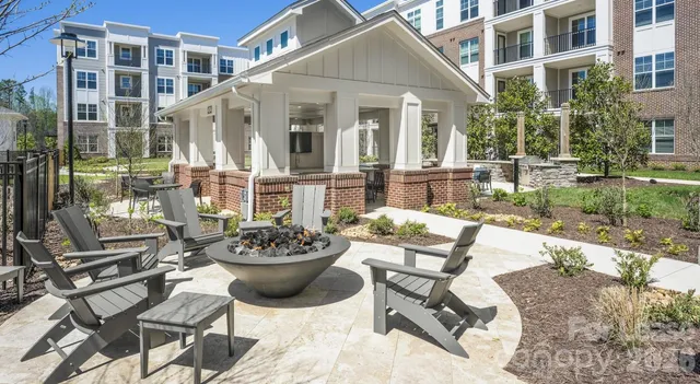 a view of a patio with couple of chairs and a fountain