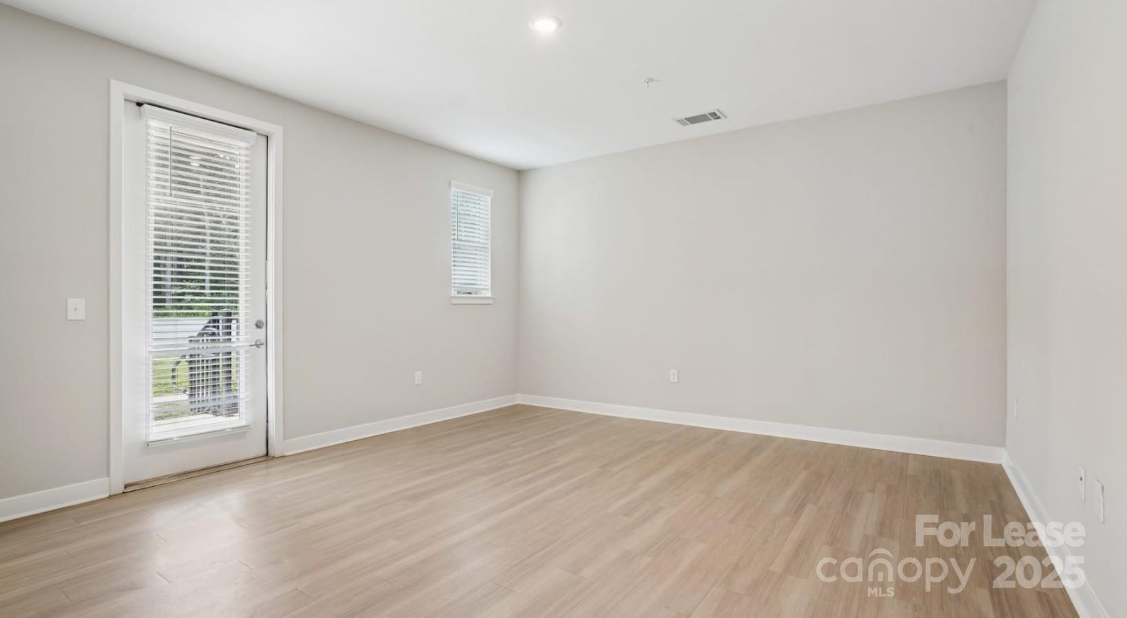 4010 Waiting Street, Unit C3 Matthews, NC 28105 - Photo 7 of 36 wooden floor in an empty room with a window