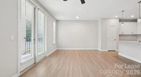 a view of a kitchen with wooden floor and a sink