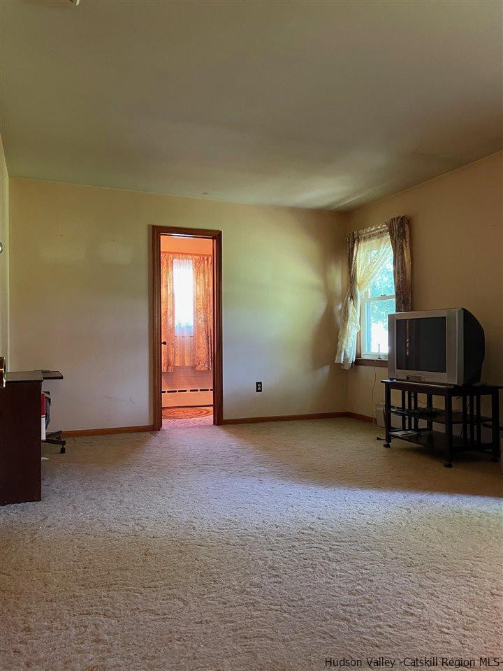 307 Blue Mountain Road Saugerties, NY 12477 - Photo 14 of 20 an empty room with windows and cabinet