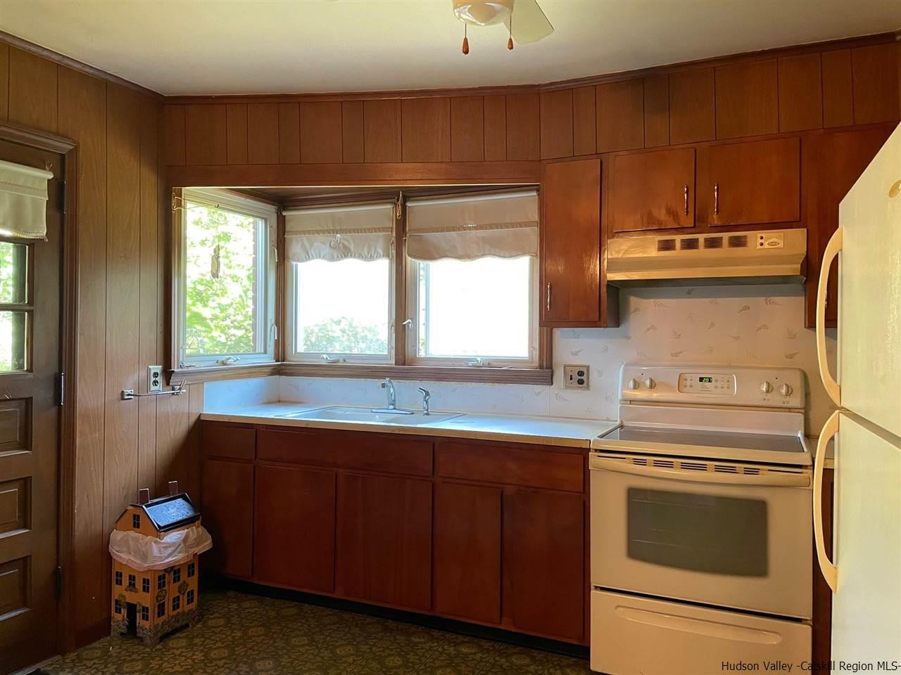 307 Blue Mountain Road Saugerties, NY 12477 - Photo 5 of 20 a kitchen with a stove a sink and a microwave